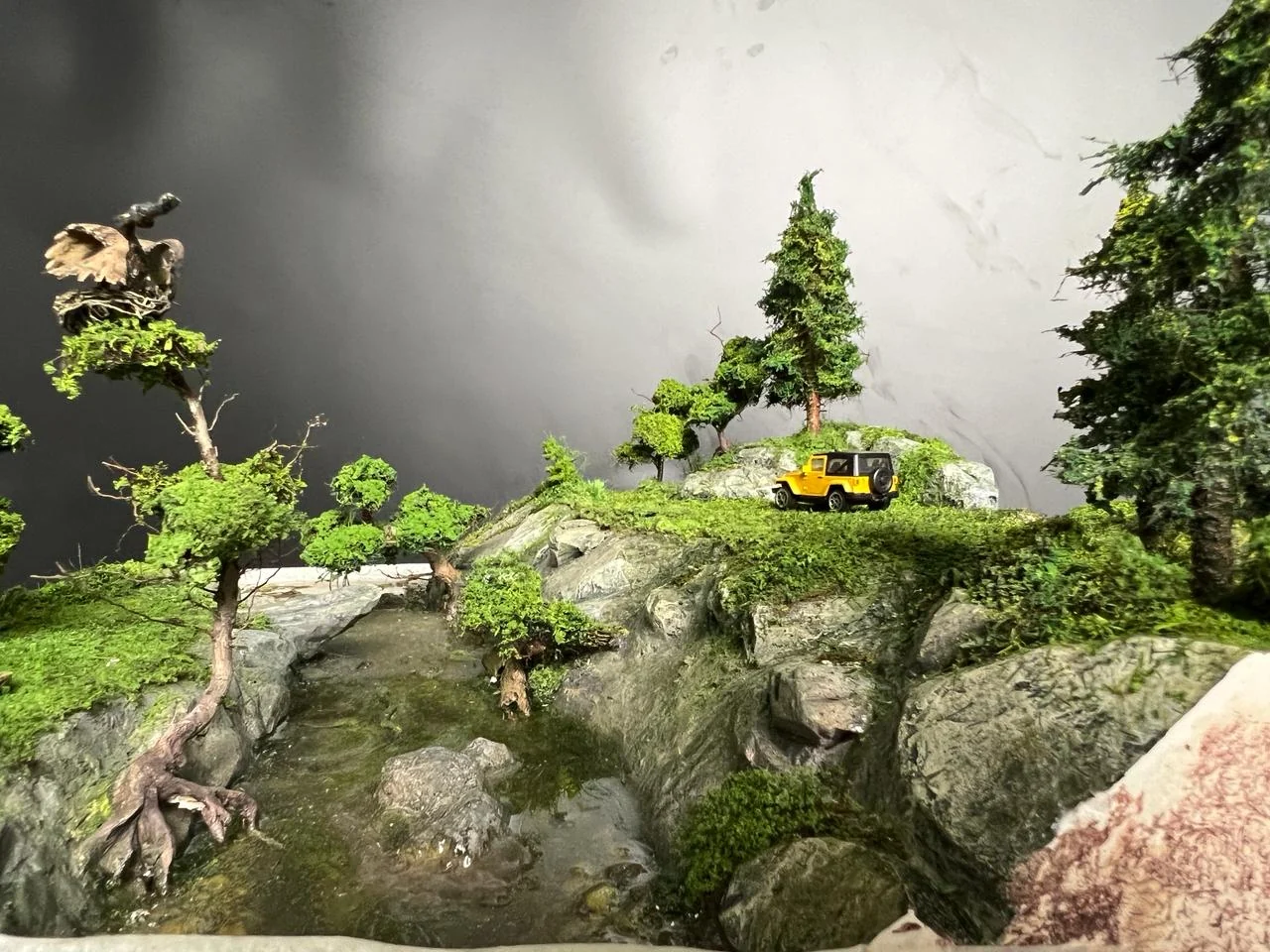 Bird detail inside a miniature countryside scene.