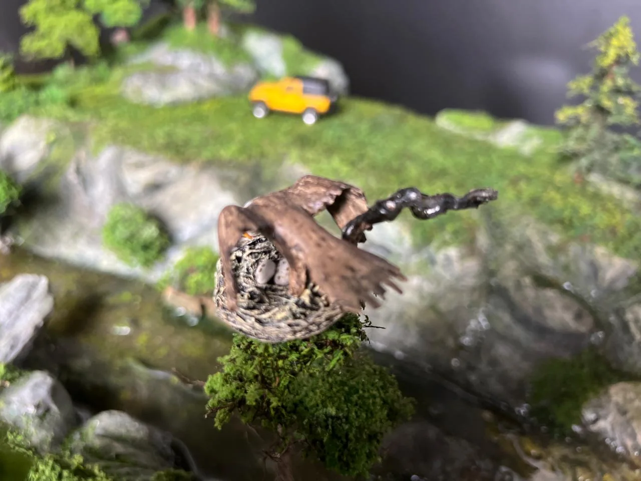 Wildlife detail inside a miniature terrain diorama.